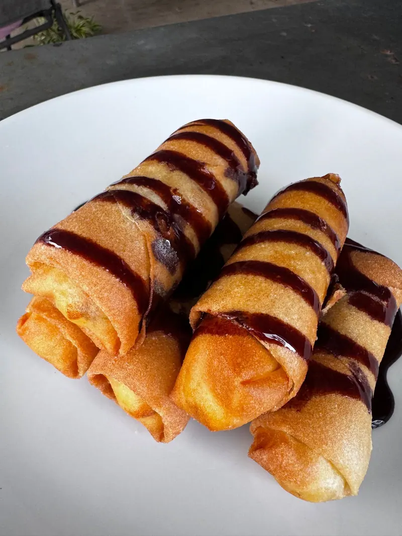 Crispy banana rolls with chocolate drizzle
