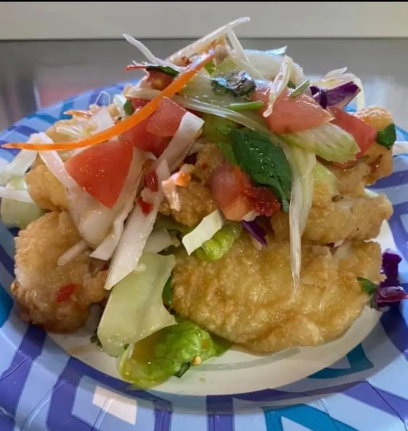 Crispy mahi-mahi topped with mango salad, tomato and herbs