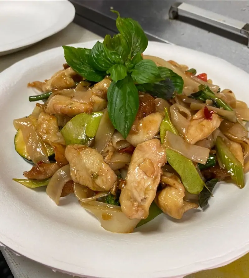 Drunken noodles with chicken, wide rice noodles, vegetables and Thai basil