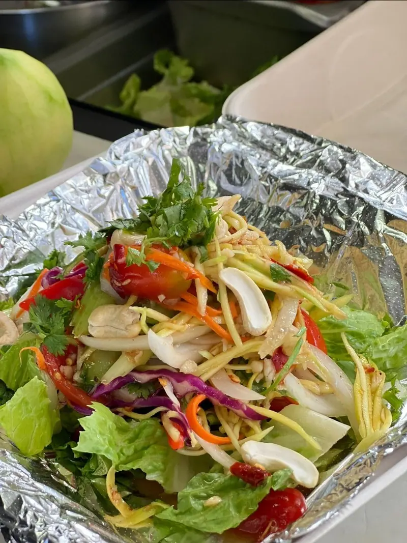 Mango salad with cashews, tomato, red cabbage and cilantro on lettuce