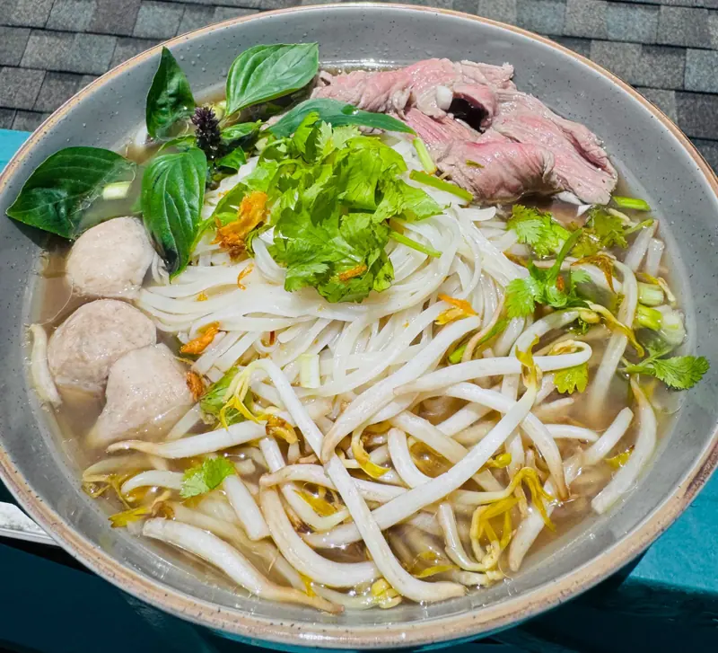 Beef pho with rare beef, meatballs, rice noodles, bean sprouts, Thai basil and cilantro