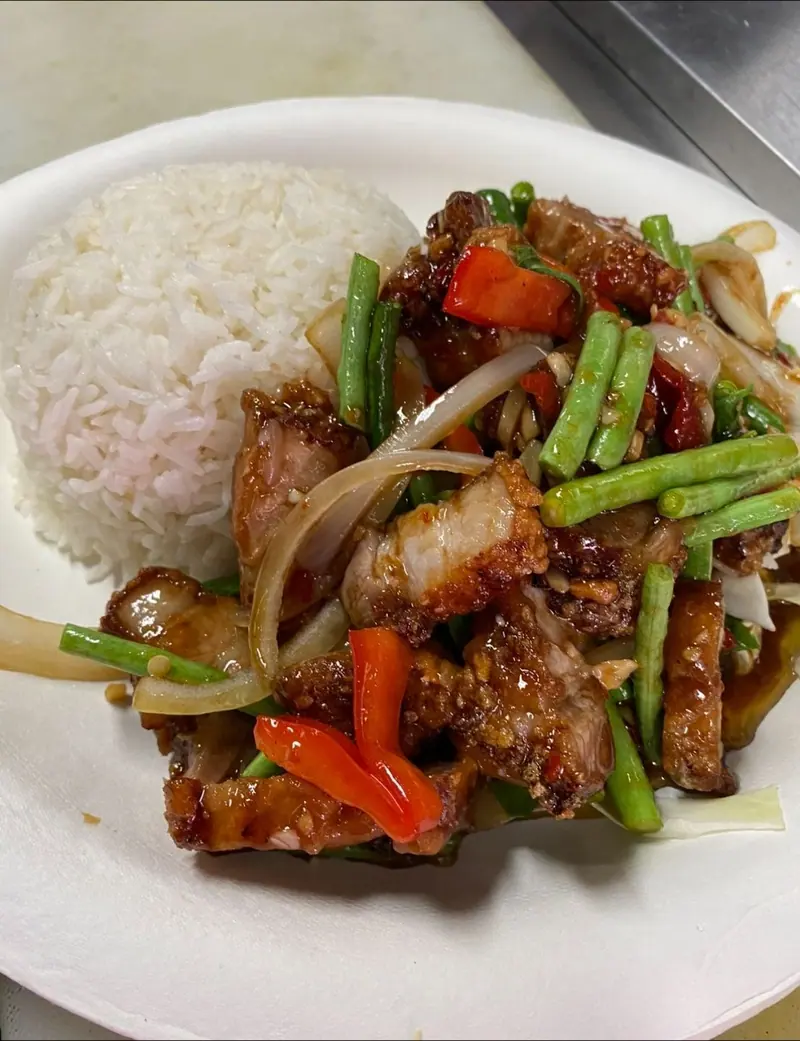 Crispy pork belly basil stir-fry with long beans, red peppers and onion, with a scoop of rice
