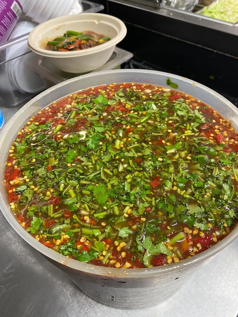 A big batch of chili sauce loaded with fresh herbs