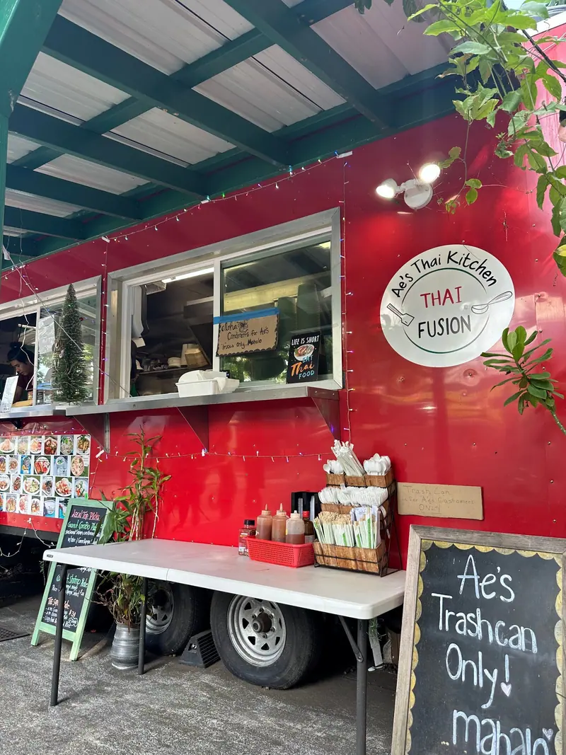 The red Ae’s Thai Kitchen truck with its round Thai Fusion sticker by the order window