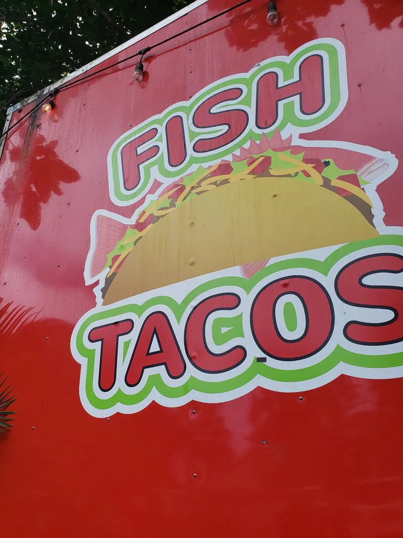 FISH TACOS painted on the side of the red truck in Hāna
